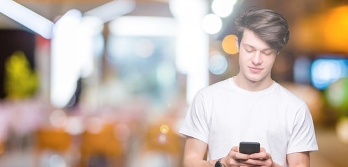 Young man using smartphone over isolated background with a confident expression on smart face thinking serious