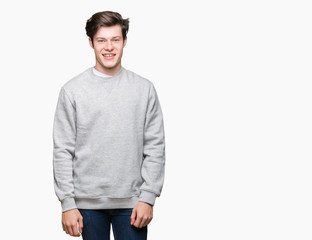 Fototapeta premium Young handsome sporty man wearing sweatshirt over isolated background with a happy and cool smile on face. Lucky person.
