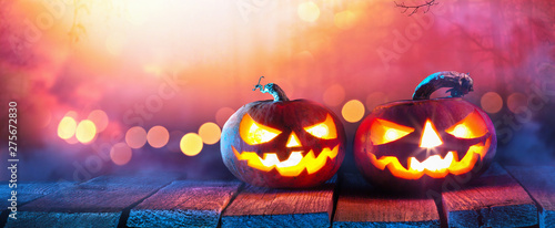Jack O’ Lanterns Glowing In Fantasy Night. Halloween Background