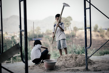 Children are forced to work in the construction area. Human rights concepts, stopping child abuse, violence, fear of child labor and human trafficking