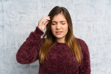 Young girl over grunge wall unhappy and frustrated with something. Negative facial expression