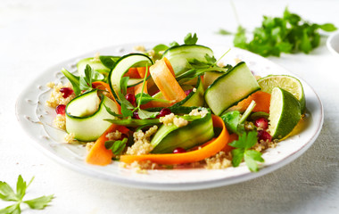 Cucumber, carrot , sugar pea and quinoa salad with pomegranate seeds. Vegan food