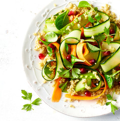 Cucumber, carrot , sugar pea and quinoa salad with pomegranate seeds. Vegan food