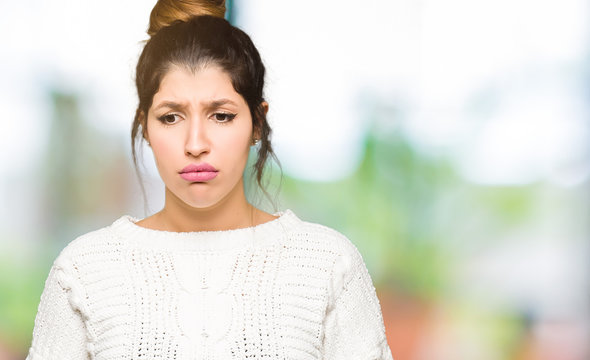 Young beautiful woman wearing winter sweater depressed and worry for distress, crying angry and afraid. Sad expression.