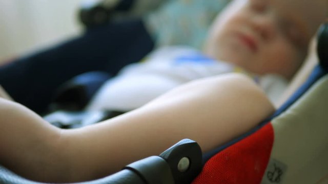 baby is sleeping in a baby stroller