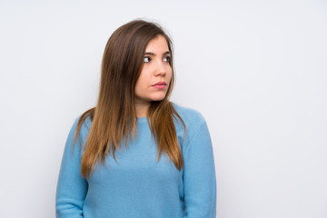 Obraz premium Young girl with blue sweater standing and looking side