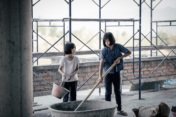 Children are forced to work in the construction area. Human rights concepts, stopping child abuse, violence, fear of child labor and human trafficking