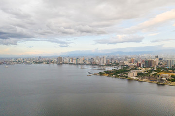 Naklejka premium Manila city in the morning, view from above. Panorama of a large port city. City with modern buildings and skyscrapers. Manila, the capital of the Philippines. Asian metropolis.
