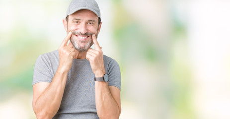 Handsome middle age hoary senior man wearing sport cap over isolated background Smiling with open mouth, fingers pointing and forcing cheerful smile