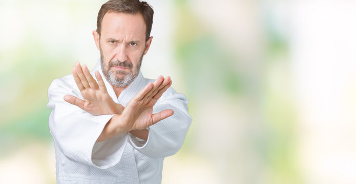 Handsome Middle Age Senior Man Wearing Kimono Uniform Over Isolated Background Rejection Expression Crossing Arms And Palms Doing Negative Sign, Angry Face