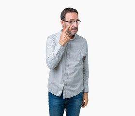 Handsome middle age elegant senior man wearing glasses over isolated background Pointing to the eye watching you gesture, suspicious expression