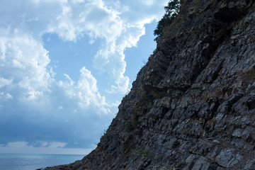 Balancing mountain on top of balancing rock . Diagonal across the sea .