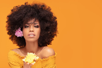 Beauty afro woman with fresh flowers.