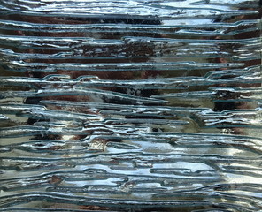 Silver color horizontal abstract pattern texture metal and glass glare glared shining shiny wet mirror mirrored reflection effect surface background 