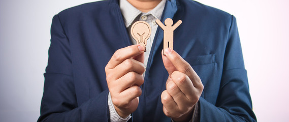 Wood figure with business icons in finance concept.