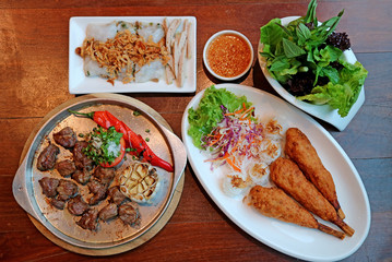 Top view of popular Vietnamese dishes on the wooden table 