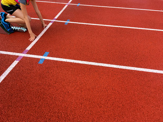 Girl ready to start racing on a track