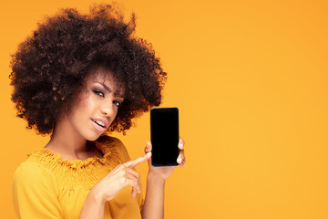 Excited afro girl with mobile phone.
