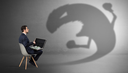 Young businessman staying and  negotiate with a monster shadow
