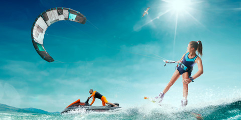 Kite surfing and water scooter in tropical ocean.