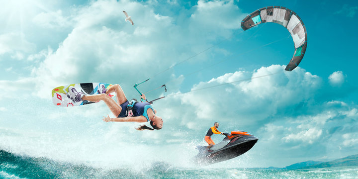 Kite surfing and water scooter in tropical ocean.