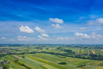 Fototapeta premium Aerial view of farmlands and mountains in rural Poland seen from drone. Summer time.