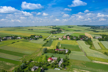 Aerial view of farmlands and mountains in rural Poland seen from drone. Summer time.