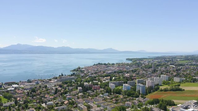 Aerial slow panning around Morges agglomeration, Lake Leman in background. Vaud, Switzerland