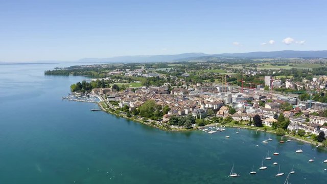 Aerial flying above Lake Leman towards Morges medieval center, Vaud, Switzerland