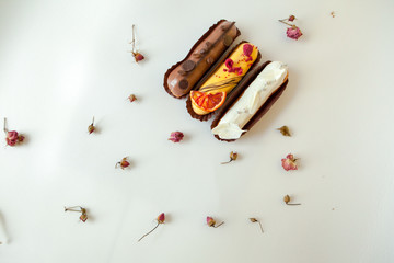 Set of three eclairs with different fillings and design. Isolate on a white surface decorated with...