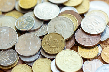coins old rusty brass euro Seychelles Bulgaria China Germany pile pack heap stack on a wooden background finance economy investment savings concept mock up selective focus close up