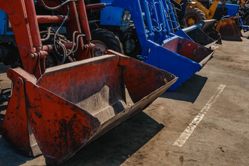 the tractor plows the field against a dramatic sunset