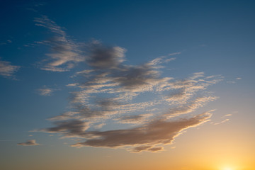 Cloudscape with light clouds against a sunset sky background, Italy