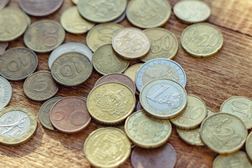 coins old rusty brass euro Seychelles Bulgaria China Germany pile pack heap stack on a wooden background finance economy investment savings concept mock up selective focus close up