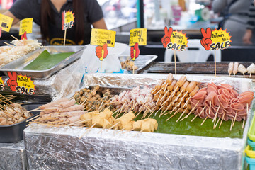 Thai street food. Meatballs, hot dogs, sausages in the market.