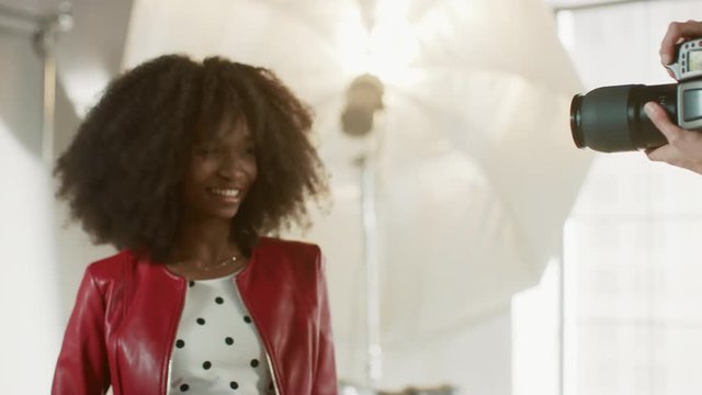 Backstage of the Photo Shoot: Make-up Artist Applies Makeup on Beautiful Black Model, in a Moment Photographer Starts Taking Photos with Professional Camera
