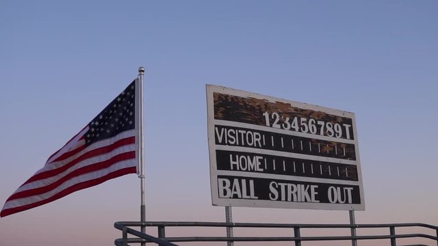 american flag in slow motion at baseball field