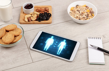 Arrangement of healthy Ingredients with a tablet. Dieting concept