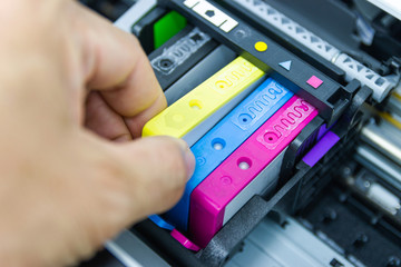 Technicians are installing the color printer inkjet cartridge