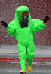 fireman wears a protective suit to extinguish a fire caused by t