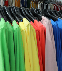 many colored cotton shirts on the hangers