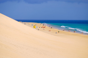 Beach Playa del Matorral with unknown tourists in Morro Jable, Fuerteventura, Canary Islands, Spain.