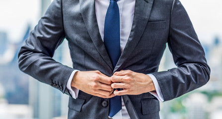 Close-up man his suit on a button in getting ready for work