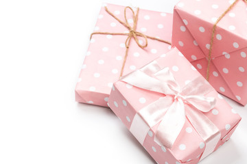 Luxury boxes tied with a pink and gold ribbon.