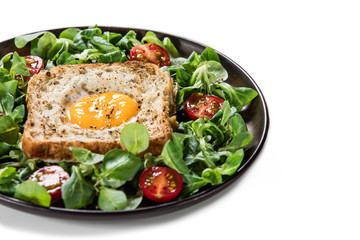 Breakfast - toasted bread with fried egg and vegetables