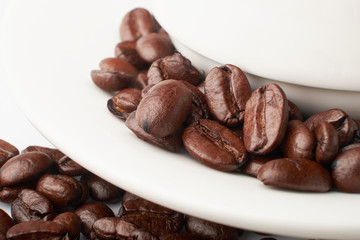 aromatic roasted coffee beans on white background