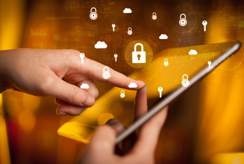 Hand holding tablet with online security system concept
