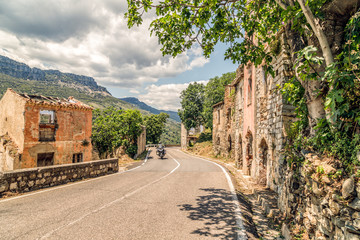 The road in the mountains to abandoned old village Gairo Vecchio, destroyed by a flood and called...