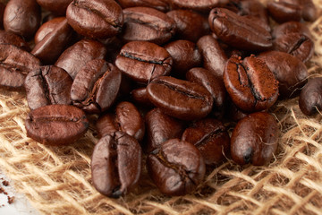 aromatic roasted coffee beans on white background