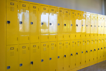 Row of yellow metal cage lockers.